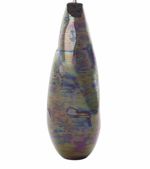This table lamp base is all about fluidity. The shape is irregular which compliments the high, glossy iridescent glaze which gives an oil like sheen of multi colours. Each lamp is hand made, ensuring a completely individual and unique finish. Simply top with a shade of your choice!