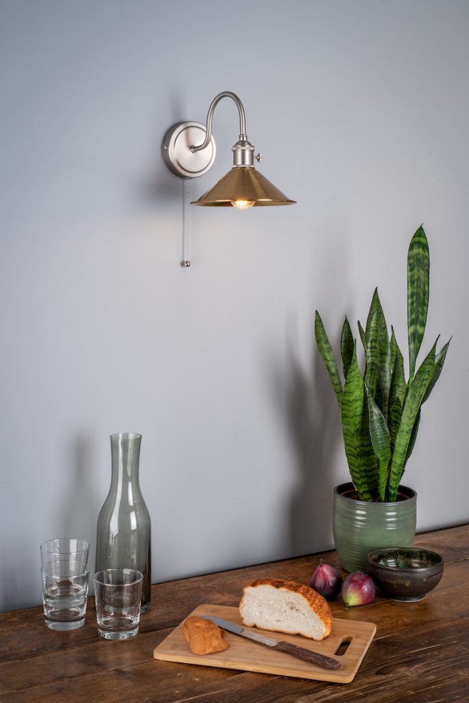 copper metal coolie shade on a industrial style wall lamp