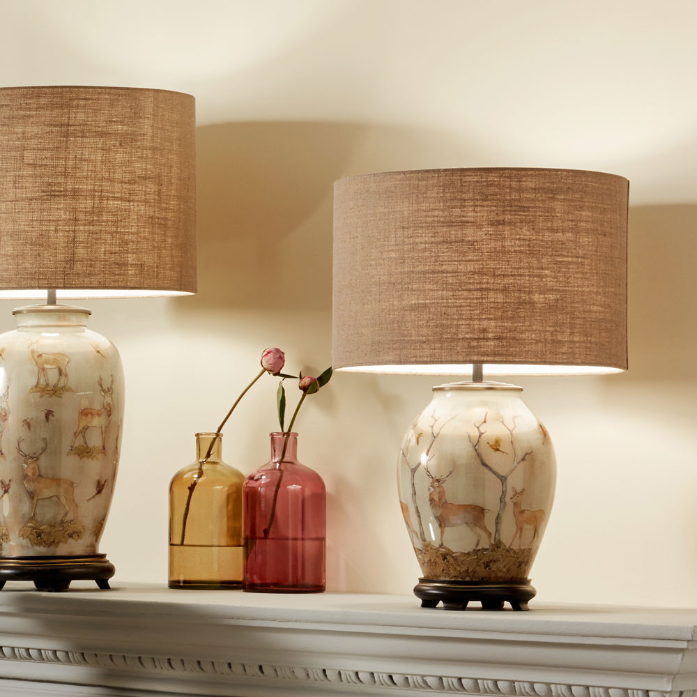 glass table lamp with stag decoration taupe drum shade