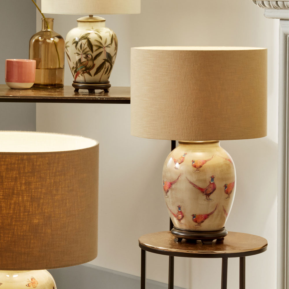 glass table lamp decorated with pheasants with neutral drum shade
