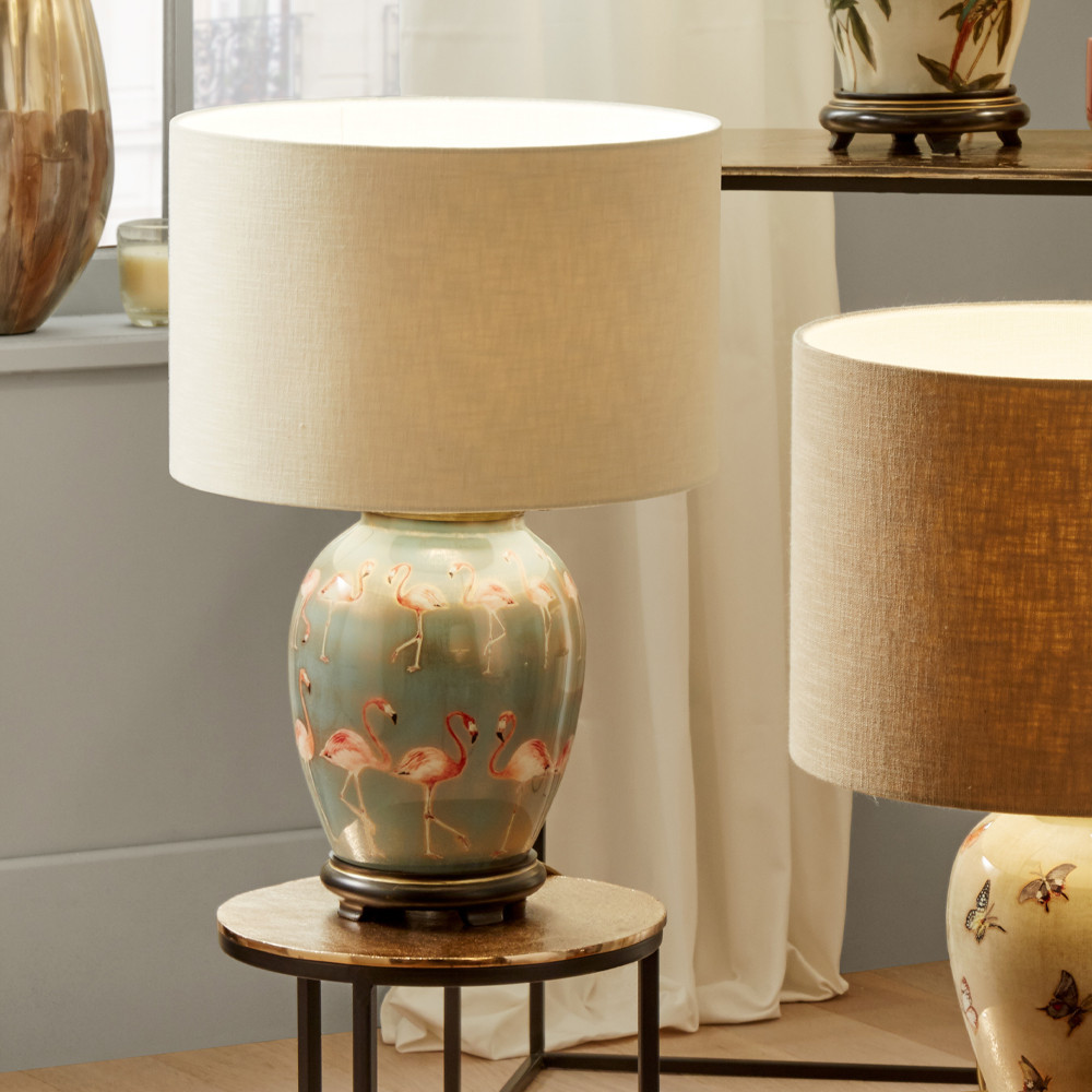 blue glass table lamp decorated with flamingos cream drum shade