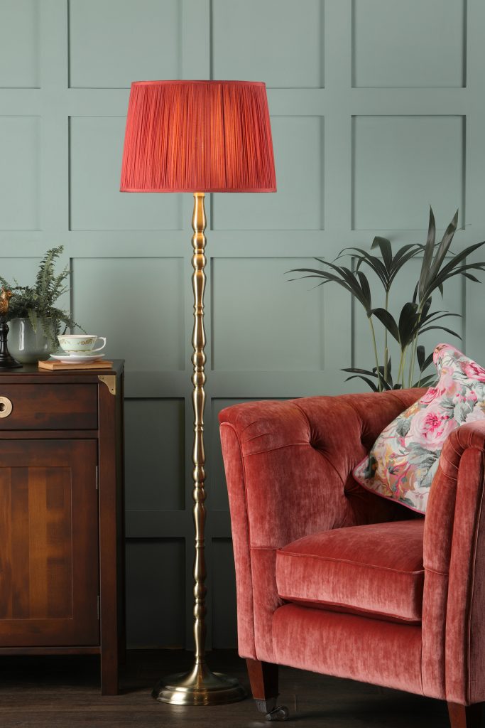 red pleated empire shade on a floor lamp