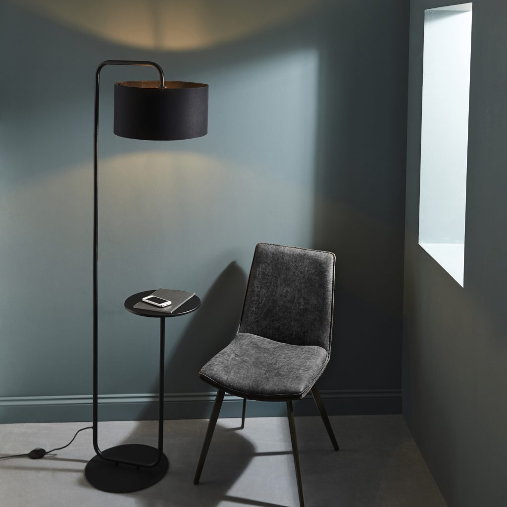 black overhanging floor lamp with table