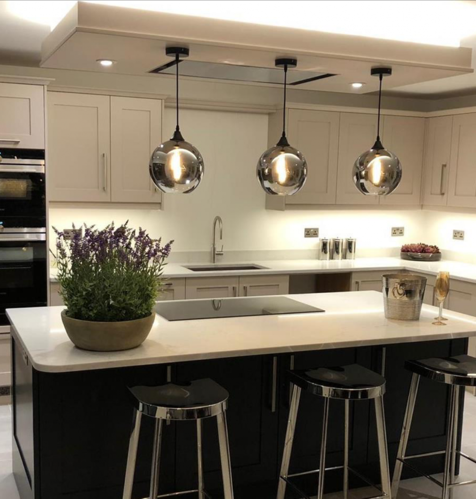 smoked glass globe ceiling pendants over kitchen island