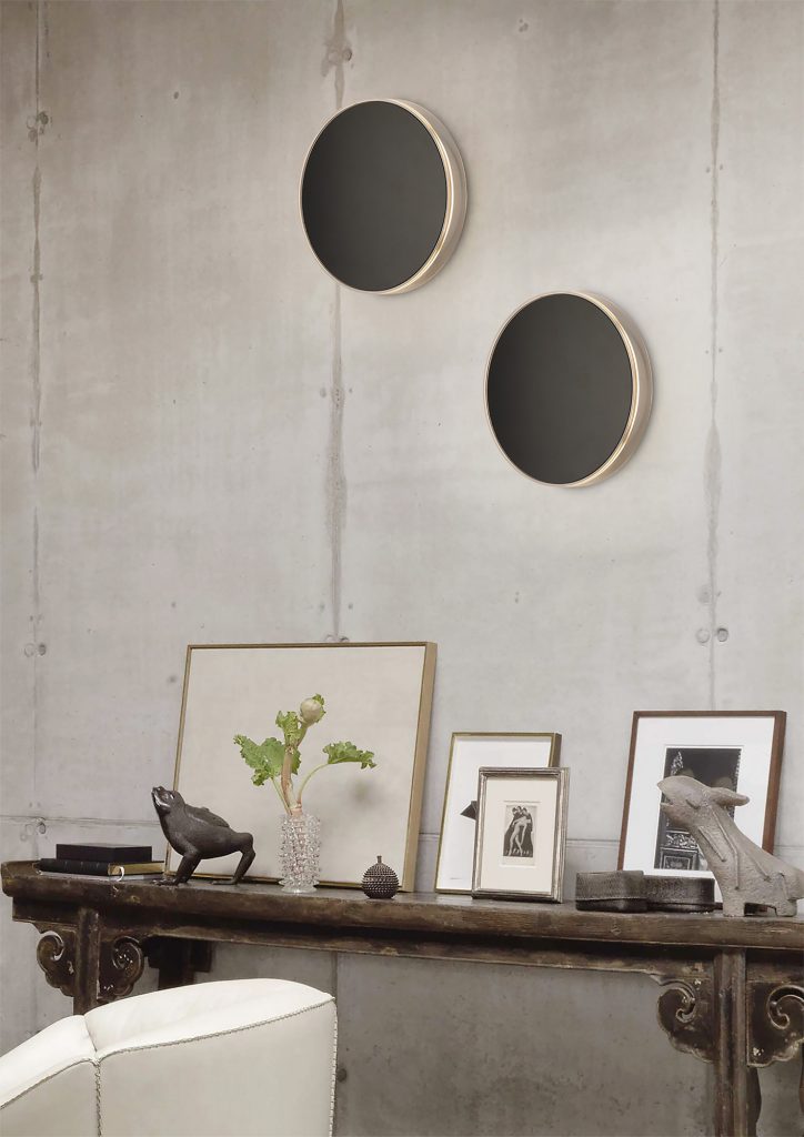modern circular black wall lights in brutalist setting