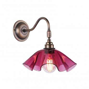 pink curved glass shade on antique brass wall light