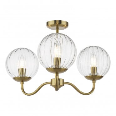 natural brass semi flush light fittign for low ceilings finished with thee segment glass globe shades