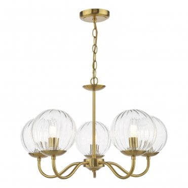 a modern five arm chandelier style pendant light in a natural brass finish with glass globe shades