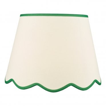 A large, neutral scallop shade lamp shade with green edge detail 