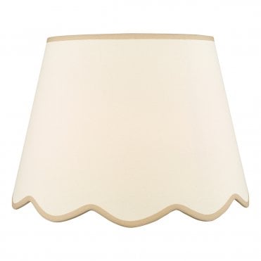 A neutral scalloped edge table lamp shade with taupe accent edging