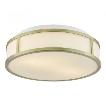 An art deco inspired flush bathroom ceiling light with aged brass frame and opal glass shade