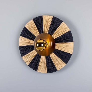 circular raffia wall light with antique brass finish