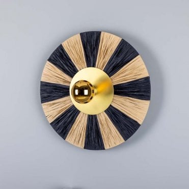 round natural material wall light with satin brass disc